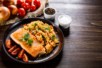 Roast salmon with groats and vegetables