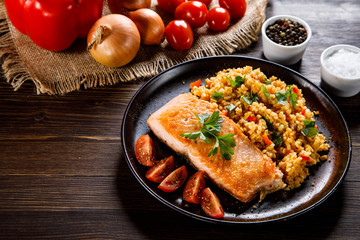Roast salmon with groats and vegetables