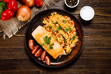 Roast salmon with groats and vegetables