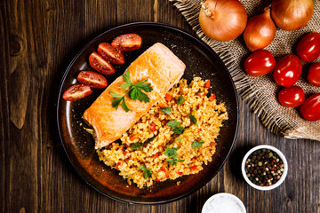 Roast salmon with groats and vegetables