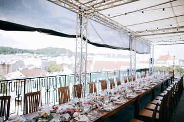 Set tables for wedding dinner  on the roof of the house