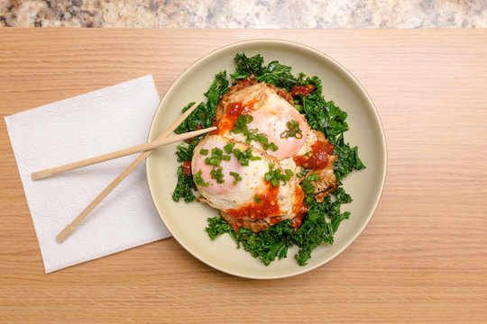 A Ketogenic Meal Consisting Of Pork And Kale Stir Fry With Fried Egg On-top.