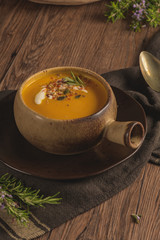 Healthy Pumpkin soup with cream and organic pumpkin seeds.