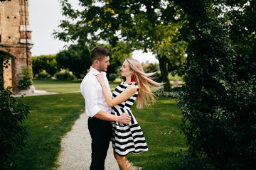 kissing  couple walk on a square somewhere in Italy
