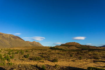 Andes mountain range against lenticular clouds in the sky
