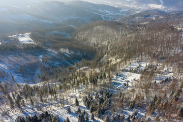 Winter scenery in Silesian Beskids mountains. View from Rownica, Ustron. View from above. Landscape photo captured with drone. Poland, Europe.