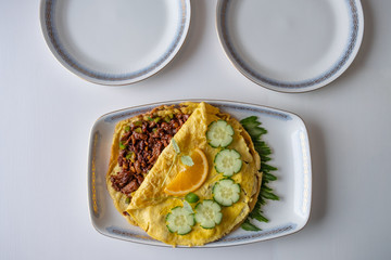 Food recipe of Omelet fried with pork chops on table