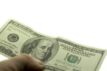 One hundred dollars in hand on a white background