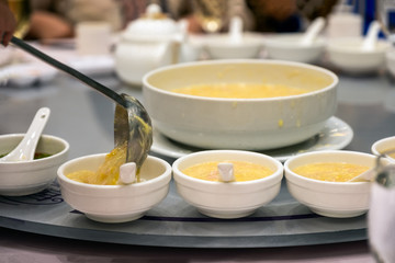 Spoon serving with corn soup on ceramic cup