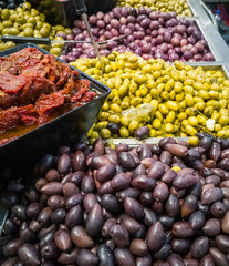 Pile of different sorts of olives, meals and pickles on Mediterranean market

