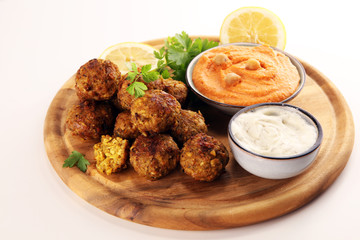 Traditional homemade hummus, falafel and chickpea served with spices on table. Jewish Cuisine.