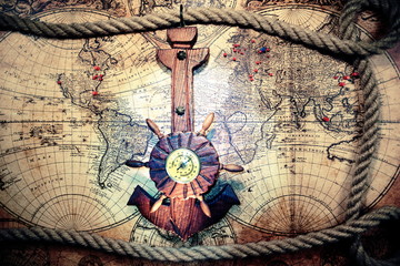 Old ship anchor,compass and rope. Travel and marine engraving background.Sea trip concept. World pirate map.Vintage and retro style.