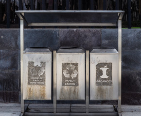 Three metal recycling containers in Ecuador.