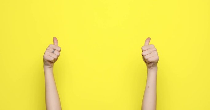 female hands pointed gesture isolated on yellow background