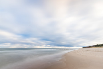 A beach in the morning with a dynamic sky