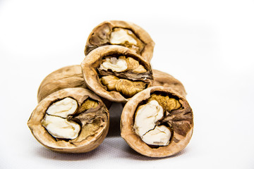 a few walnut in shell and peeled on white background