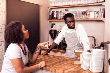 Nice joyful woman pointing with her finger