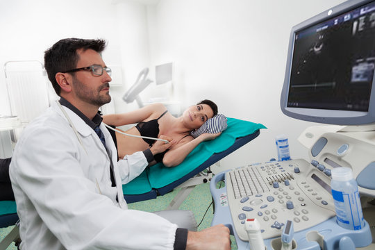 A doctor listening his female patient with a ultrasound ecography