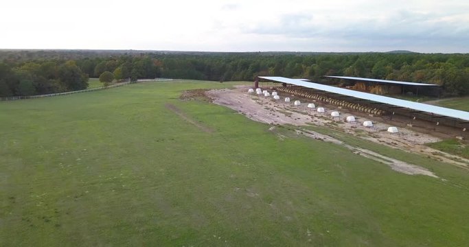 Drone shot of a dairy farm with bales of hay
