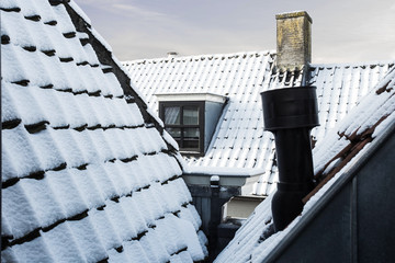 Snow covered rooftops in the city, close-up, winter beauty