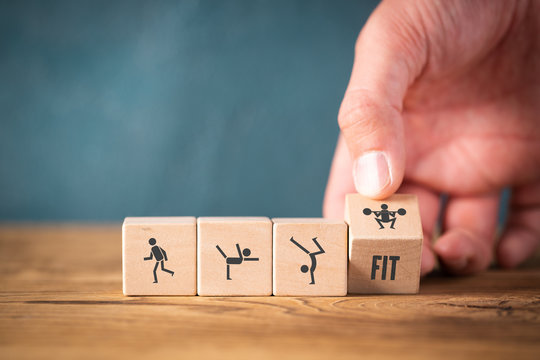 Icons on cubes symbolizing sports on wooden background