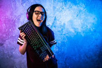 Beautiful Friendly Pro Gamer Streamer Girl Posing With a Keyboard in Her Hands, Wearing Glasses....