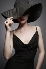portrait of young lady with black hat and evening dress