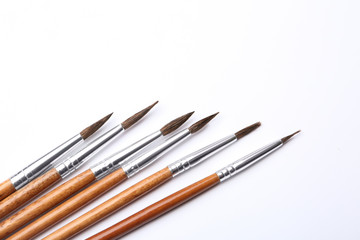 Fototapeta premium Different paint brushes on white background, top view