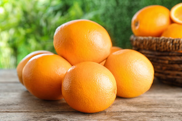 Fresh juicy oranges on wooden table. Healthy fruits