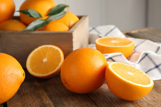 Fresh juicy oranges on wooden table. Healthy fruits