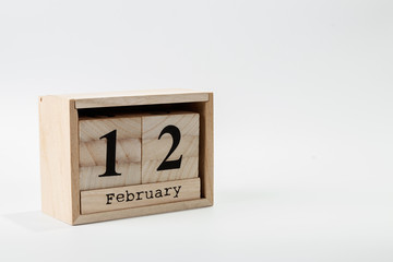 Wooden calendar February 12 on a white background