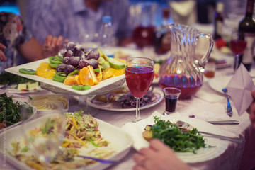 Group of people sitting at festive table and eating