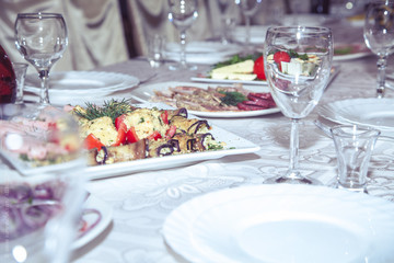 Group of people sitting at festive table and eating