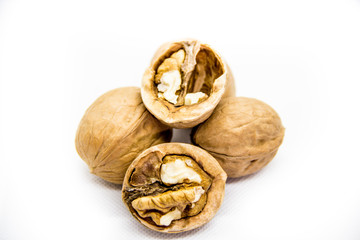a few walnut in shell and peeled on white background