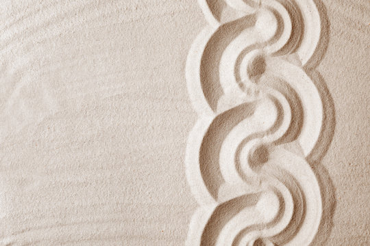 Zen garden pattern on sand as background, top view with space for text. Meditation and harmony