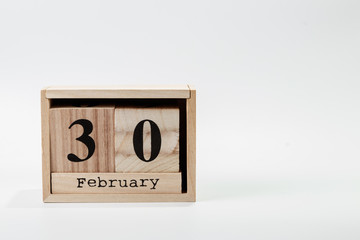Wooden calendar February 30 on a white background