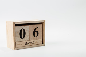Wooden calendar March 06 on a white background