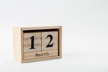 Wooden calendar March 12 on a white background