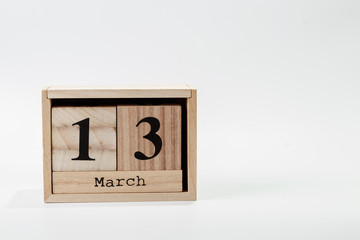 Wooden calendar March 13 on a white background