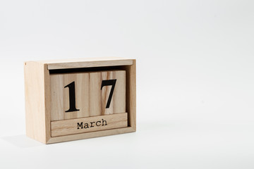 Wooden calendar March 17 on a white background