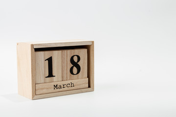 Wooden calendar March 18 on a white background