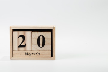 Wooden calendar March 20 on a white background