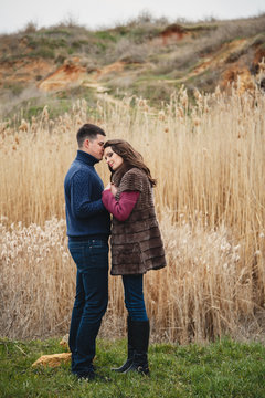 Romantic attractive young couple hugging outdoors countryside