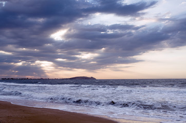 Evening on the beach, the waves wash the sandy beach, the sunset sky picturesque clouds on the horizon, the far coast, instagram.