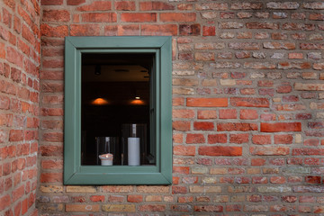 Fototapeta na wymiar window in a brick wall with candles