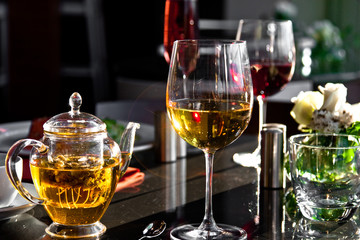 Herbal tea and glasses on table in restaurant.