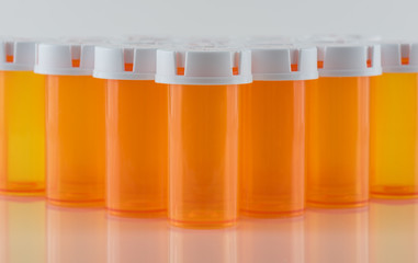 Prescription Pill Bottles on Reflective Surface