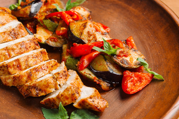 Chicken breast with grilled eggplants and peppers.
