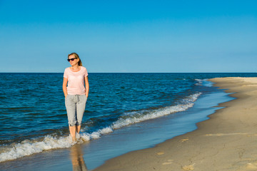 Woman waking on beach