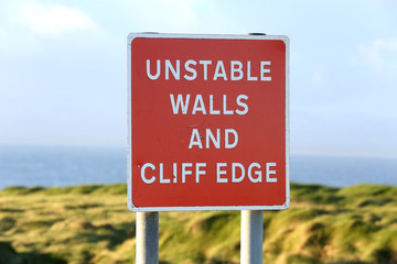 Warning Sign of unstable walls and cliff edge